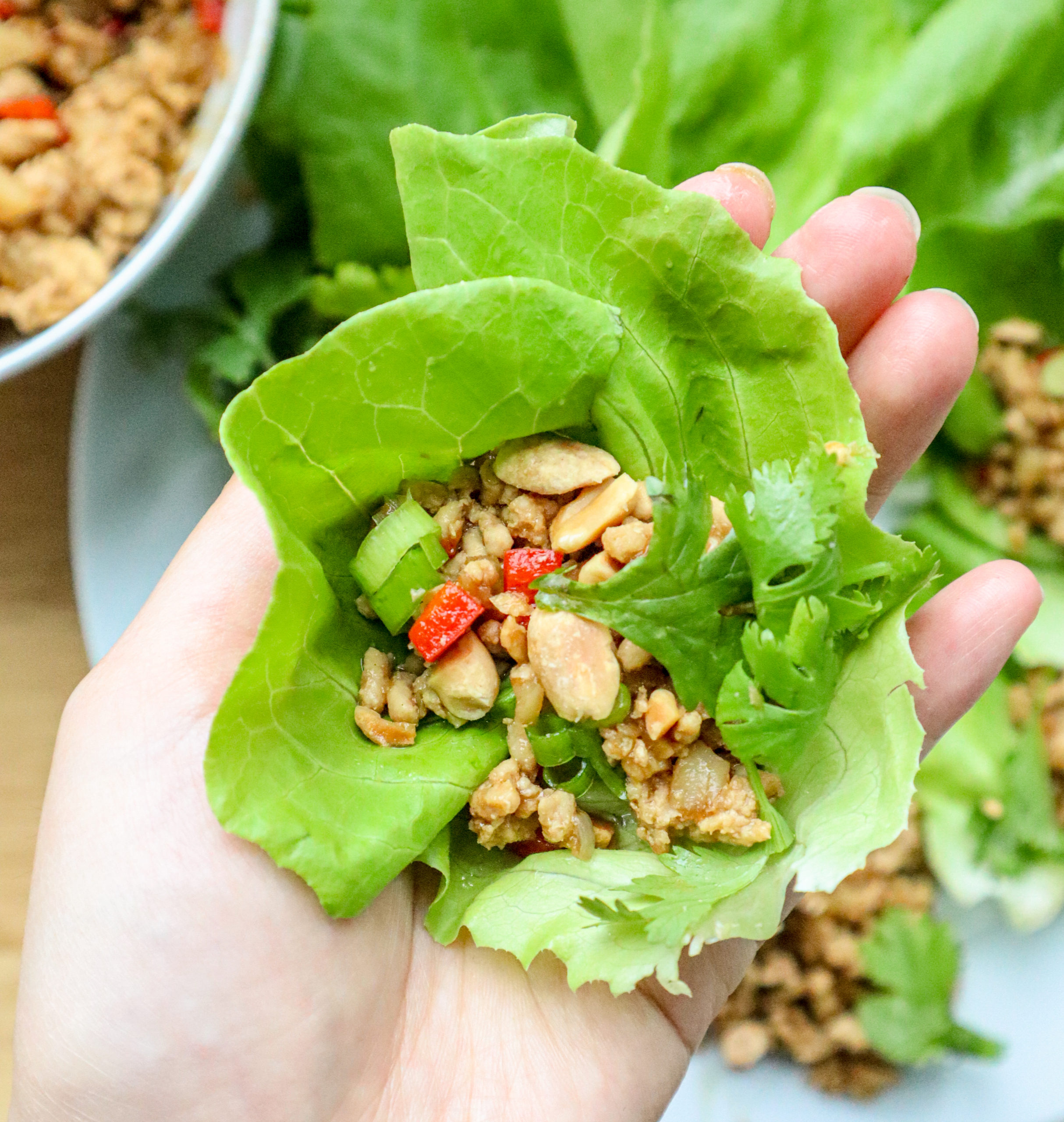 lettuce cups with hand and chicken inside