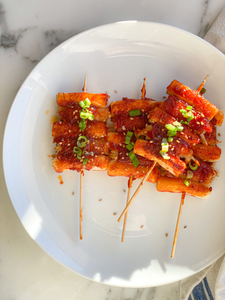bacon wrapped skewers with rice cakes called tteukbokki