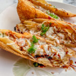 crab rangoon egg rolls stuffed with cream cheese, green onions, and imitation crab