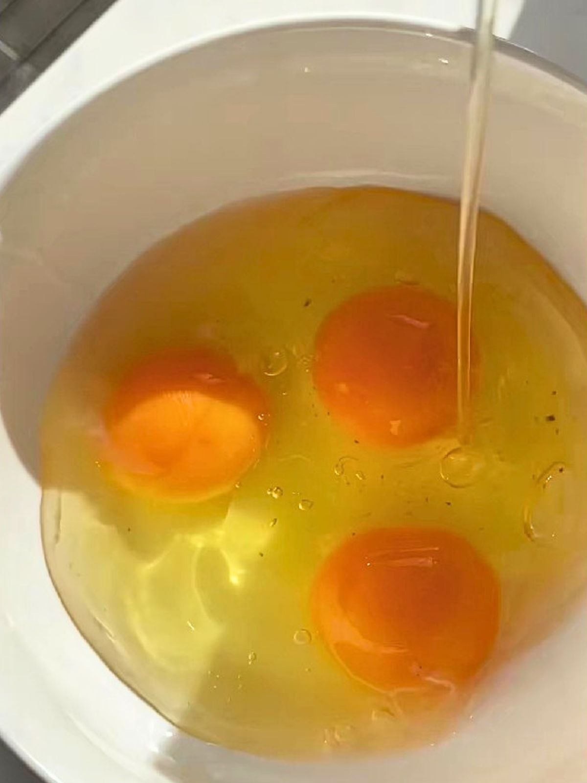3 raw eggs in a bowl.