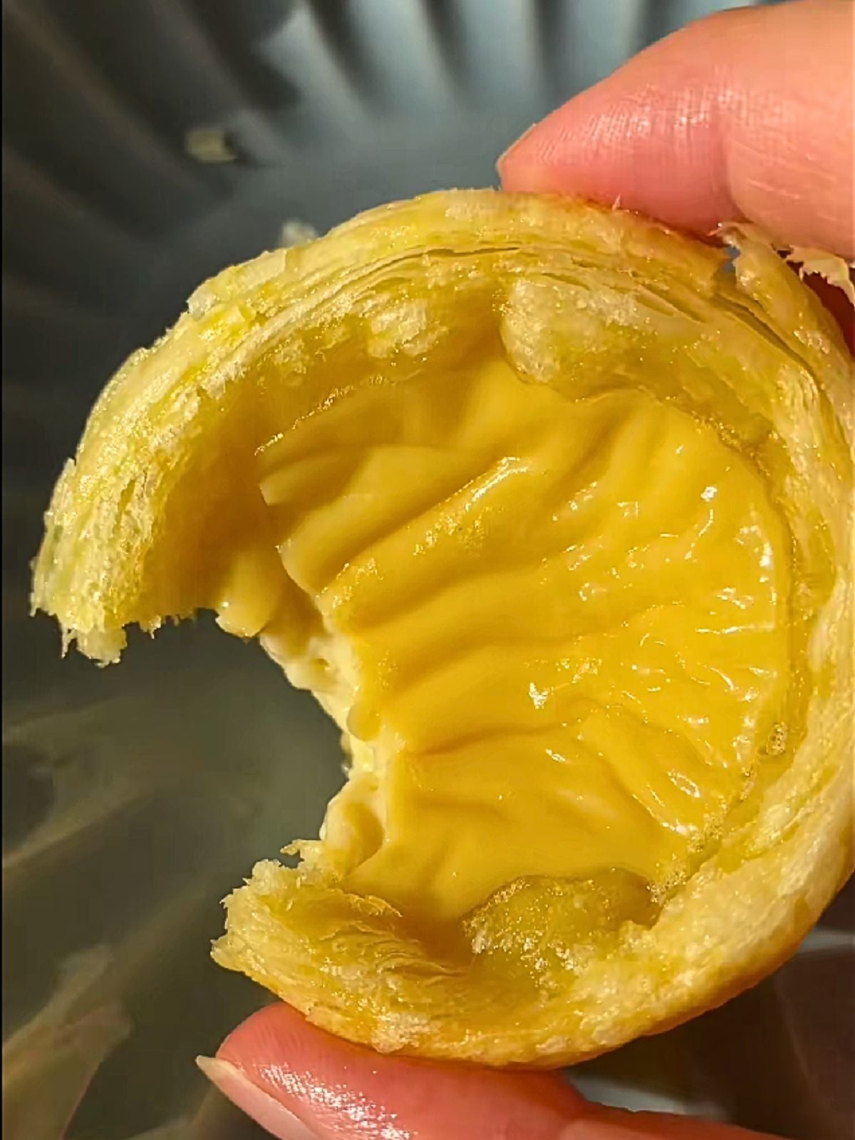 Holding an egg tart.