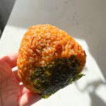 Kimchi red rice ball with seaweed.