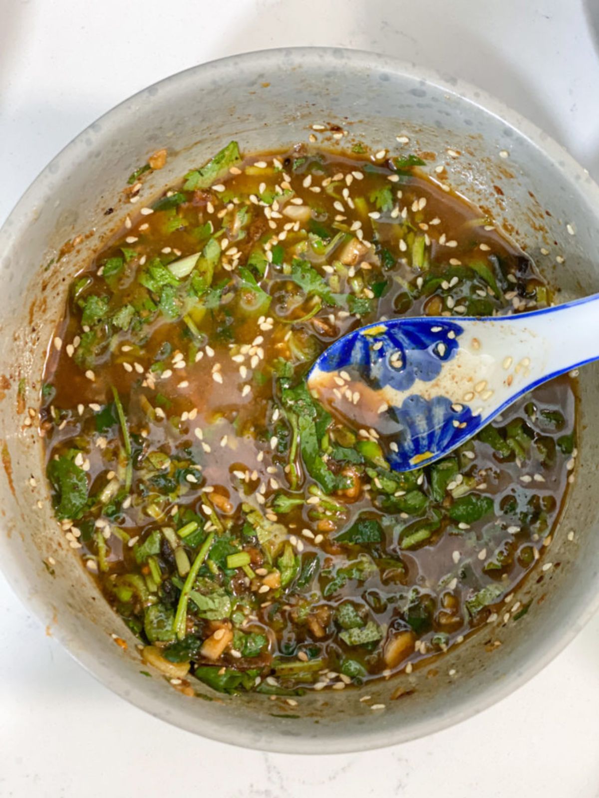Dipping sauce with cilantro, sesame seeds, and garlic.