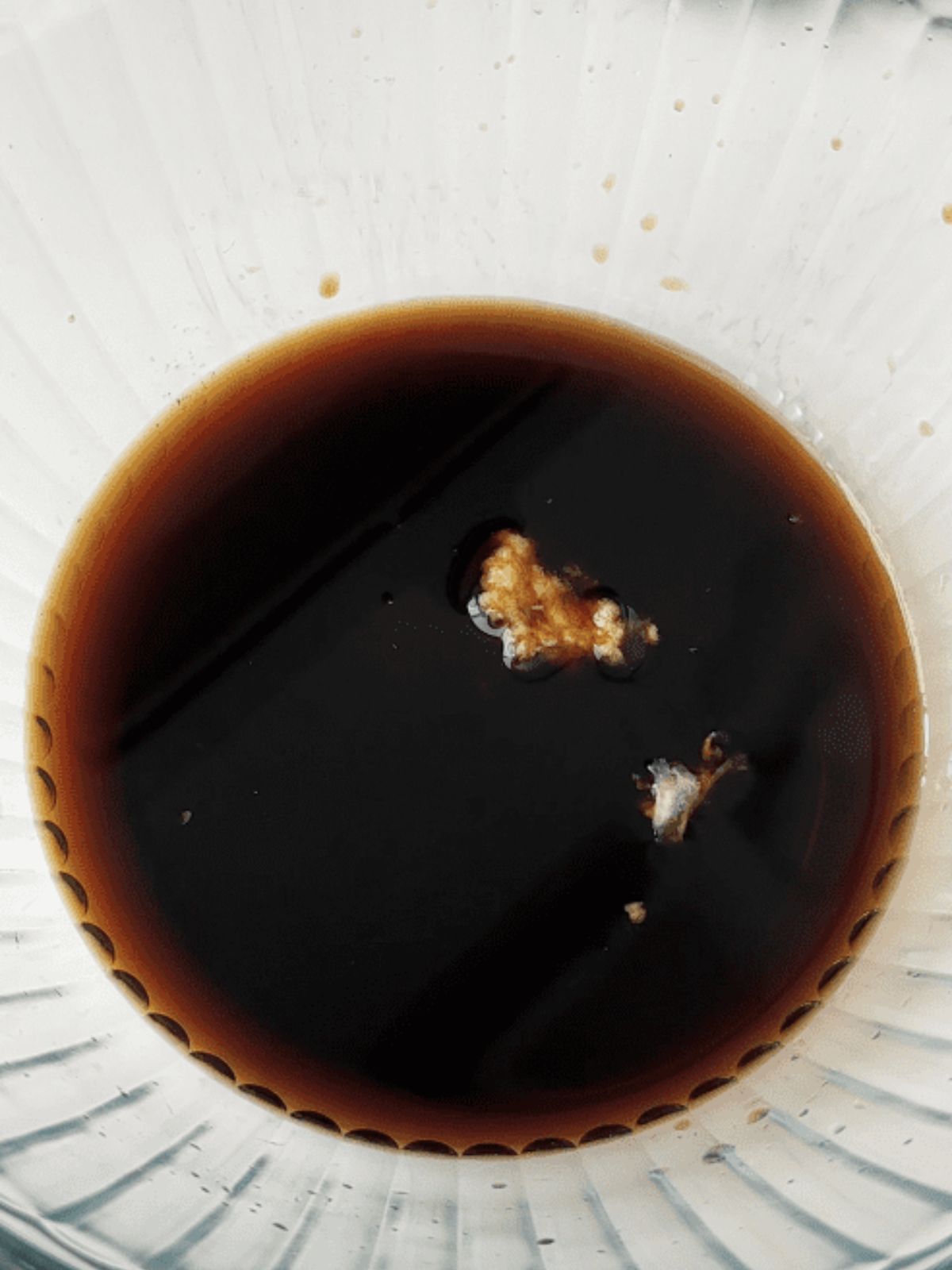Adding soy sauce and garlic in a bowl.