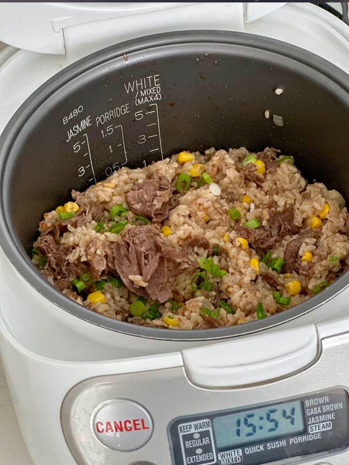 Cooked beef and corn rice in rice cooker.