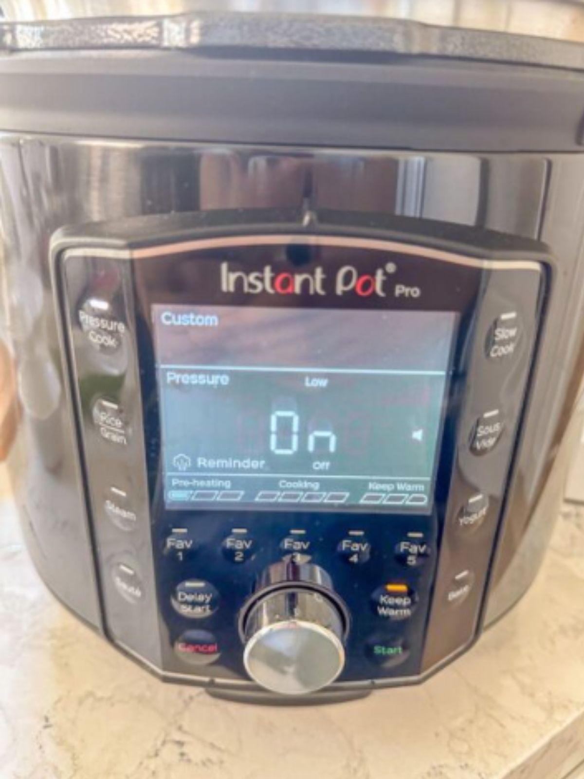 Instant Pot set to low pressure cooking for making chicken pho.