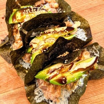 Tuna poke tacos with crispy seaweed shells, rice, tuna, topped with avocado, sesame seeds and teriyaki sauce.