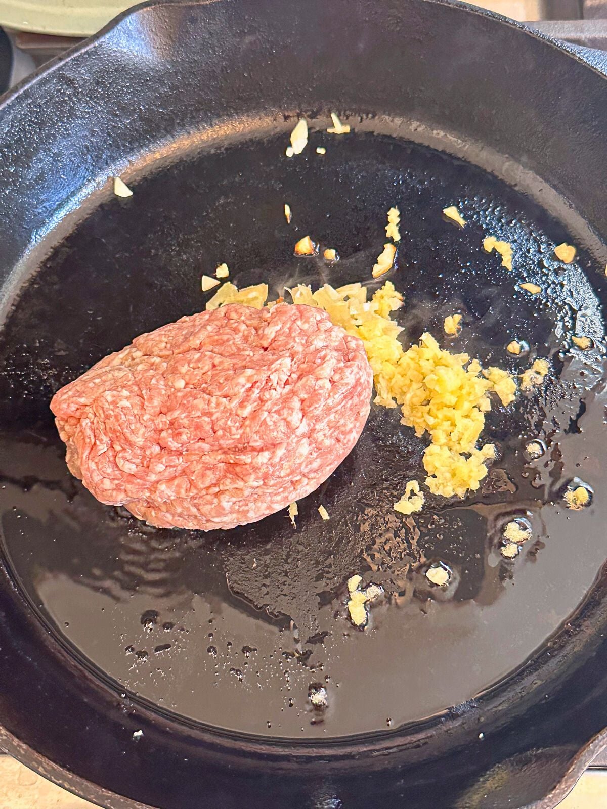 Ground pork with ginger and garlic in a pan.