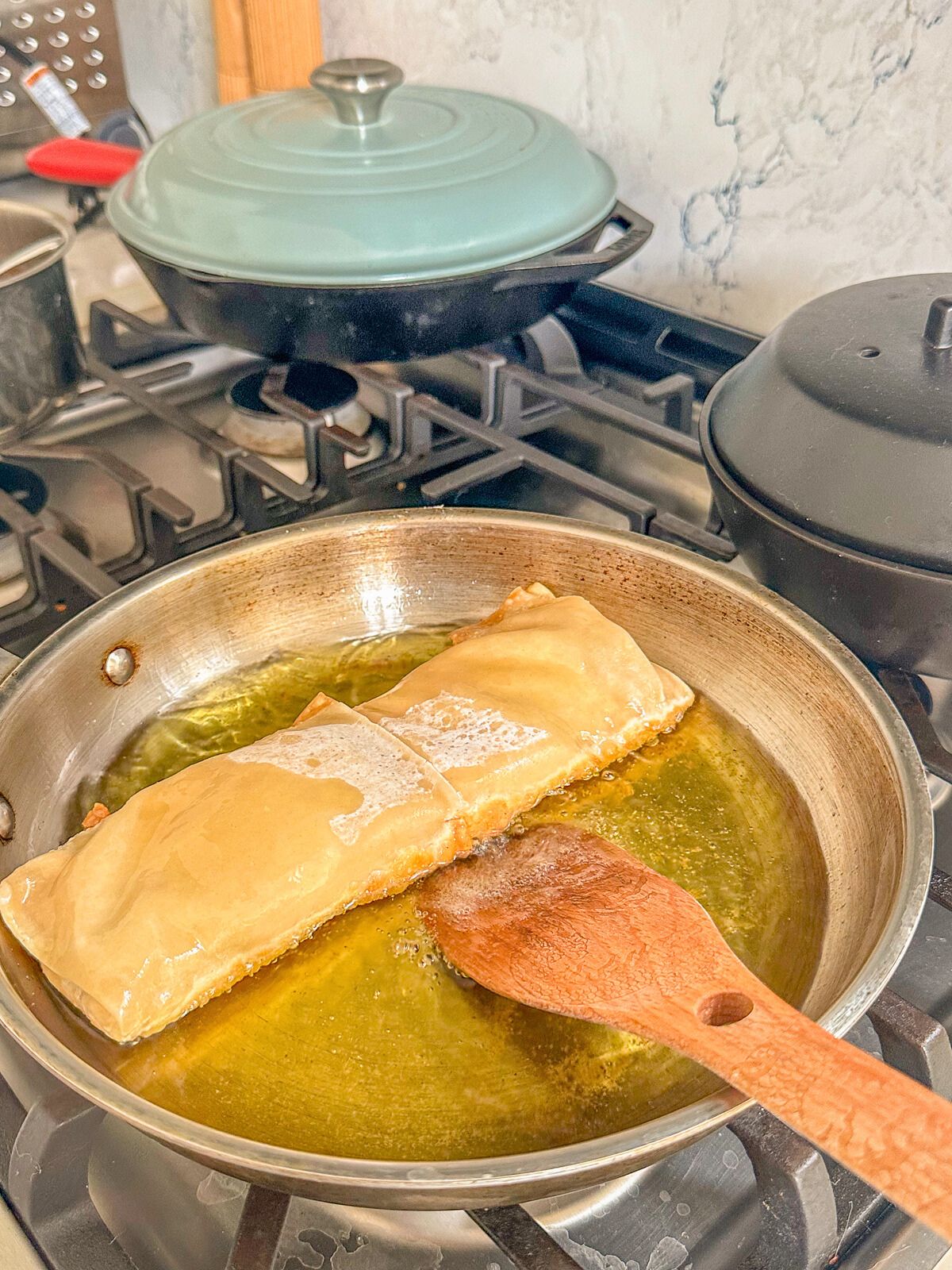 Frying the burrito in oil.