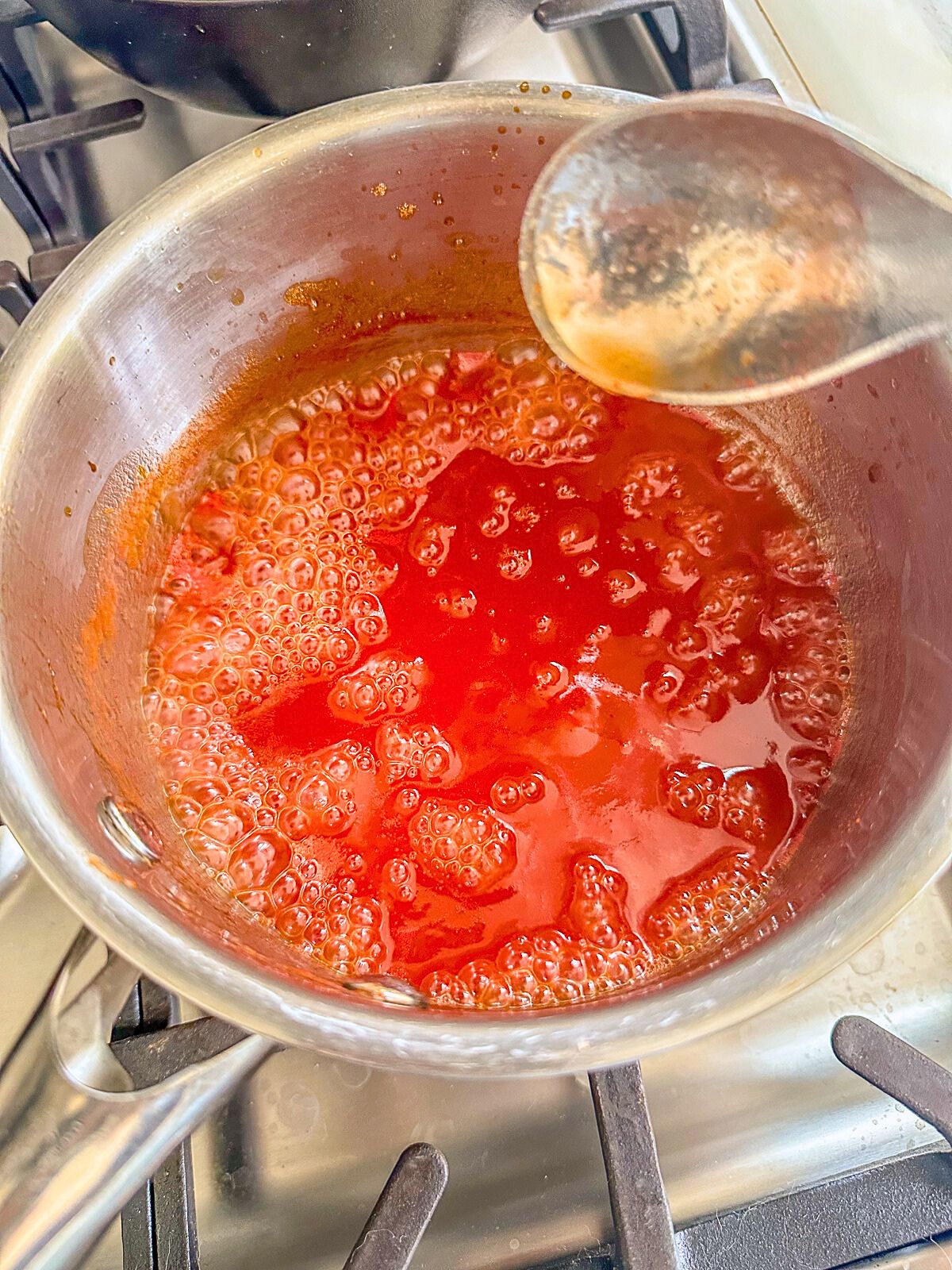 Boiling red sauce in a pot. 