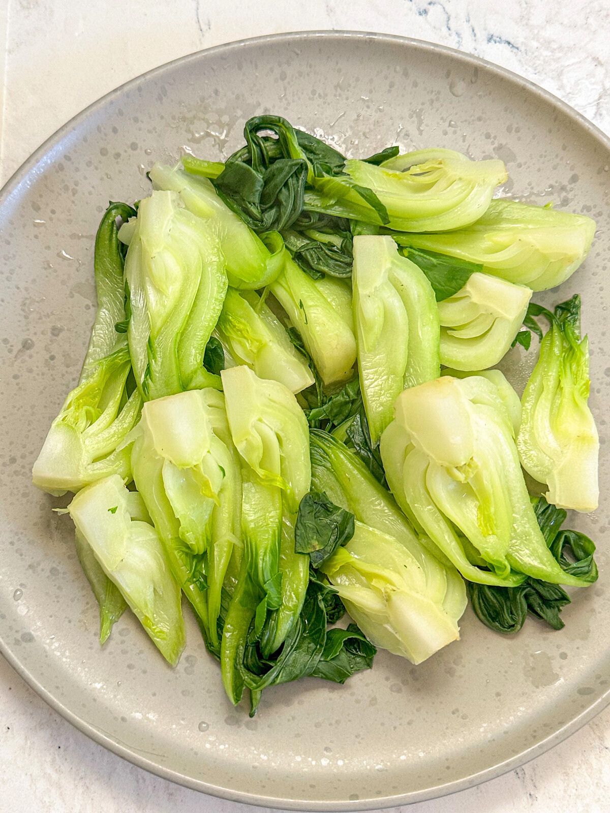 A plate of cooked bok choy.