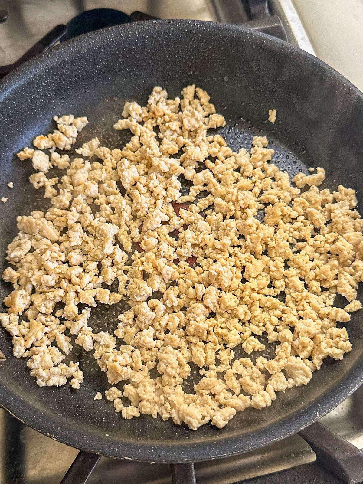 Cooked ground meat in a pan.