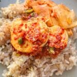 Sliced silken tofu in a spicy, savory Korean sauce topped with green onions and sesame seeds, served over rice.