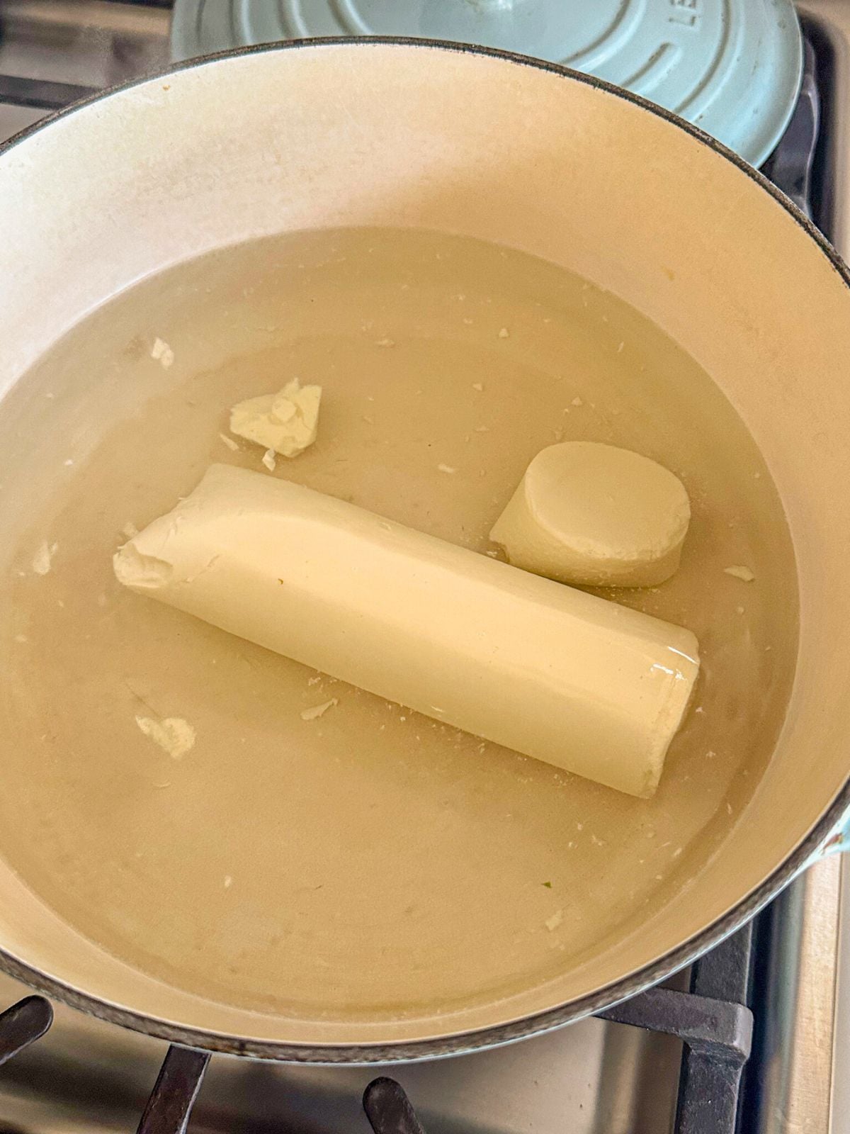 Silken tofu placed in a pot of water for boiling.