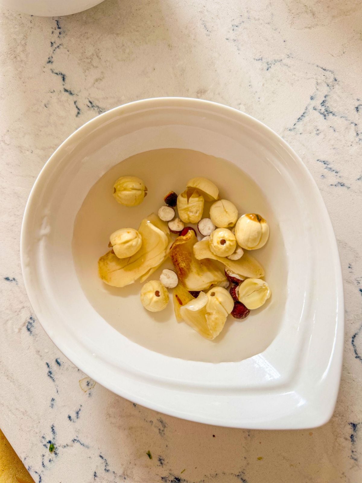 A bowl of Chinese herbs soaked in water.