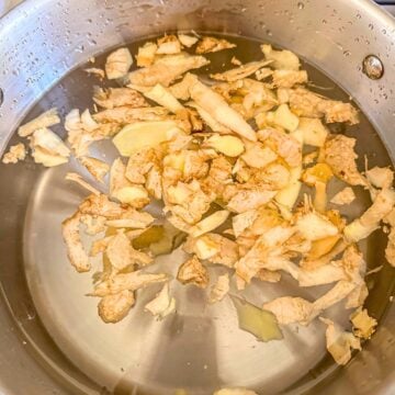A pot of water with ginger peelings.